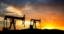 oil gas pumps exploration equipment silhouettes working in the sunset