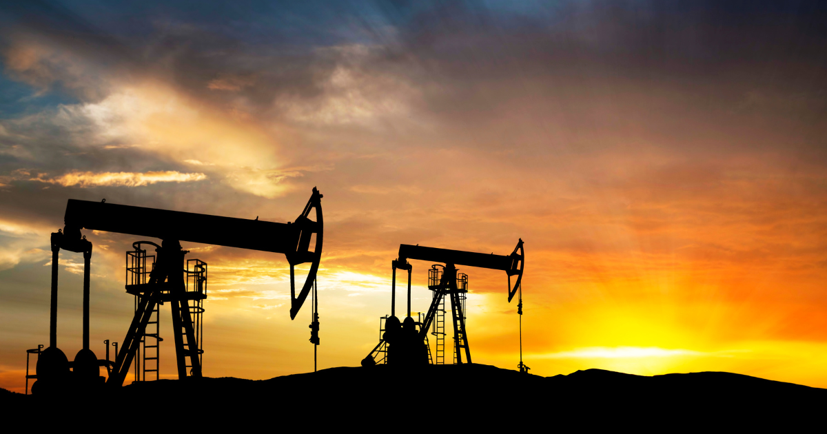 oil gas pumps exploration equipment silhouettes working in the sunset